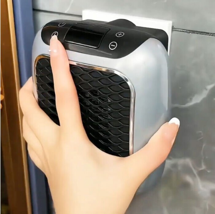 Hand operating the heater controls