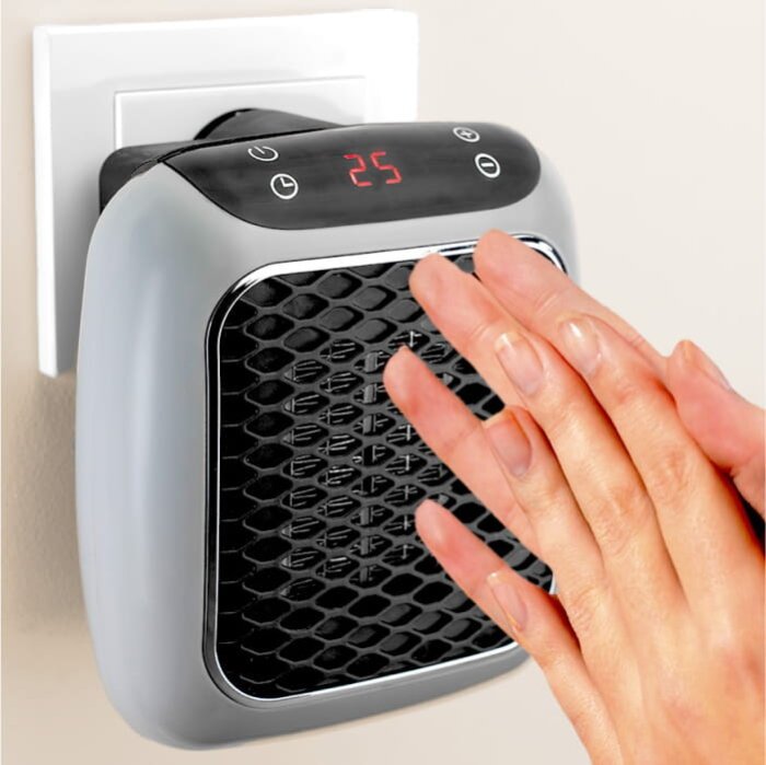 Hands held near a portable heater
